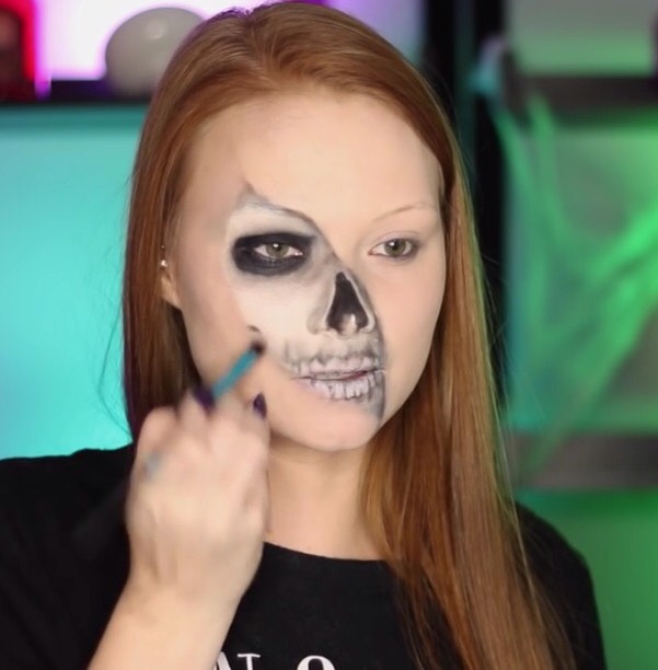 Ever so lightly, with a little black shadow define the corner of the cheek bone .
