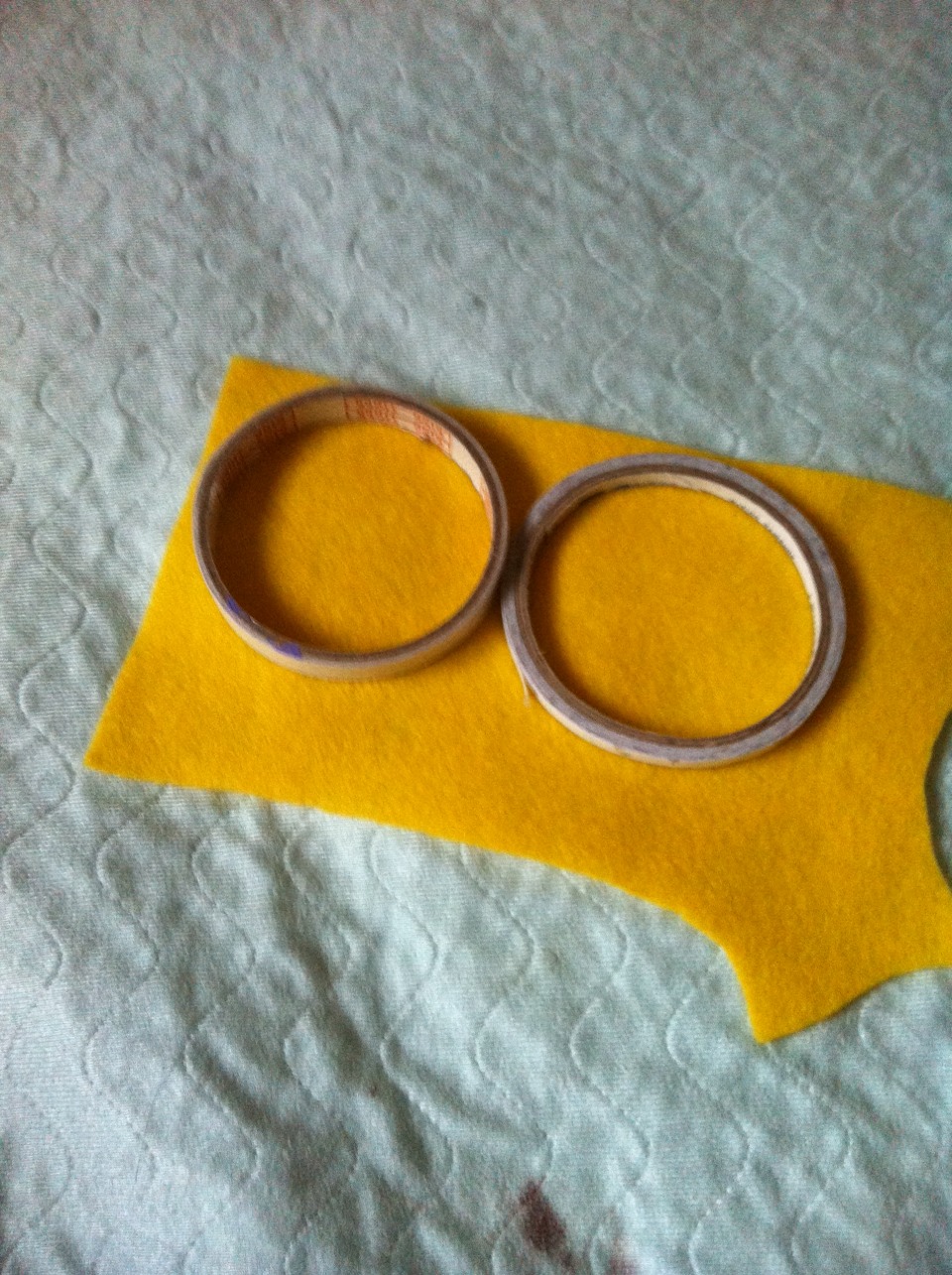 Trace a circle on the yellow felt. You can make different sizes by using different circles to trace with. Eg. Lids, glue stick cap, cup... I used a double sided tape roll
