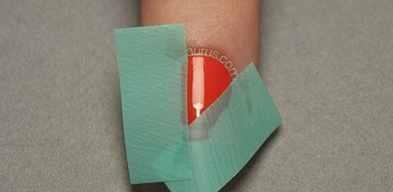 Place two strips of tape on your nail to mark off your first patch - it can be absolutely any shape but I've gone with a triangle.
