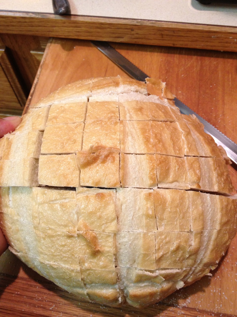 First start off with a round sourdough roll & cut it into squares like so but be sure to not cut all the way through 