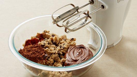 2) In large bowl, break up cookie dough. Add hazelnut spread, cocoa, chili powder and cinnamon. Beat with electric mixer on low speed about 2 minutes or until well blended.