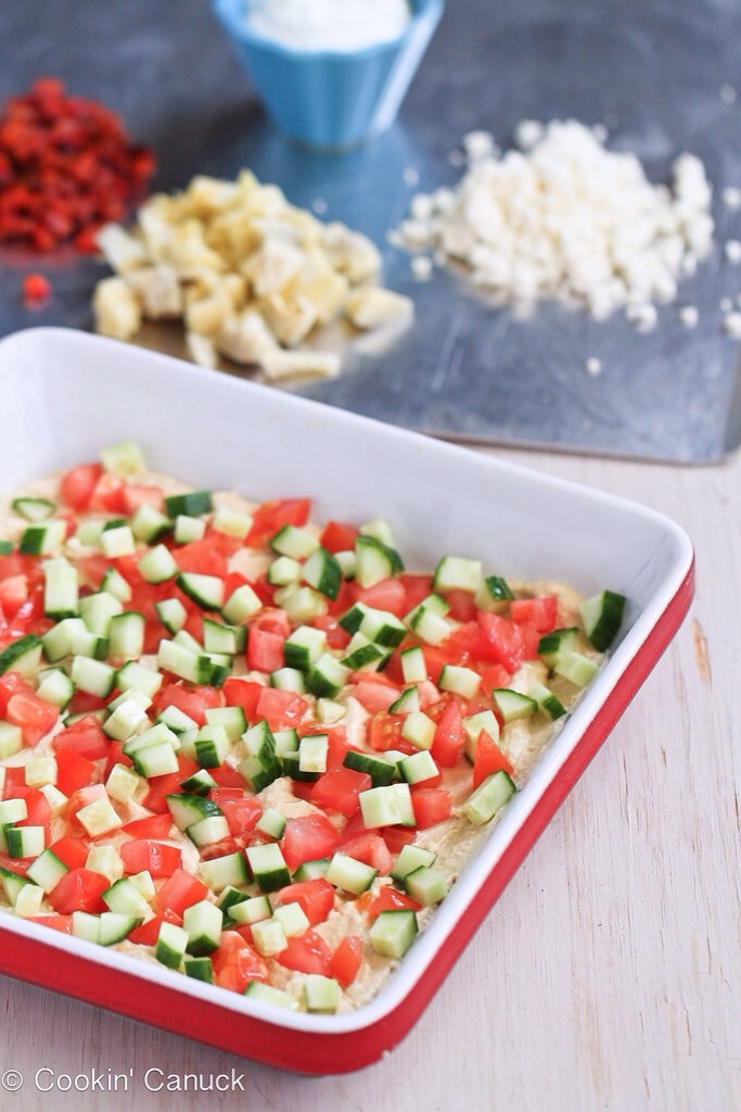 -> In an 8- by 8- square serving dish, spread the hummus evenly on the bottom. Layer the tomatoes and cucumber over top.