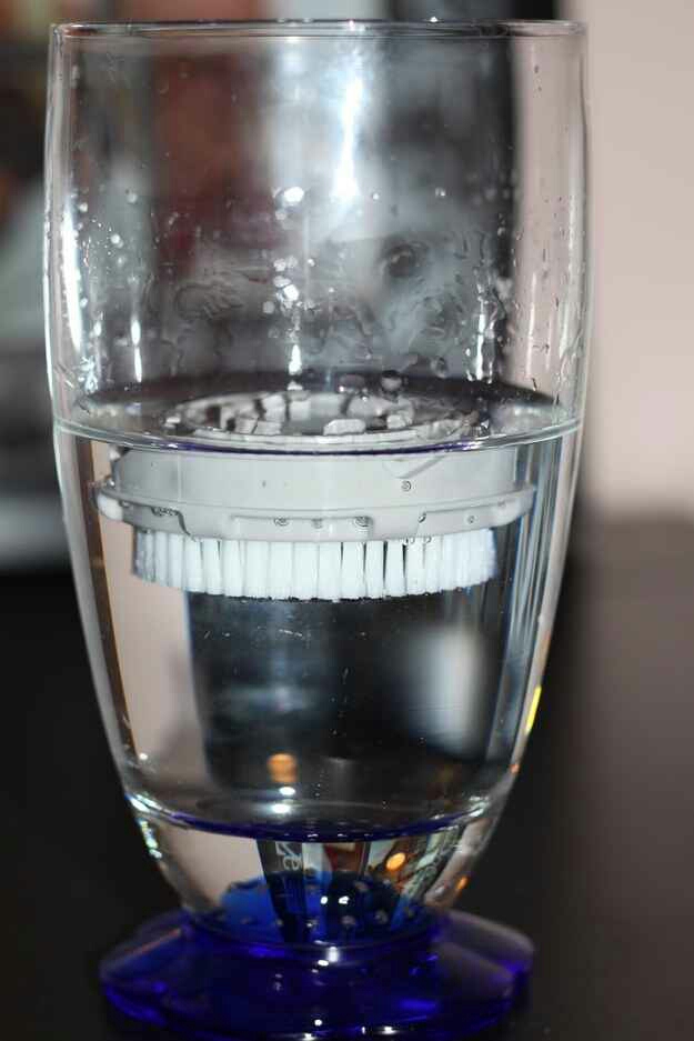 5. Mix baby shampoo and hydrogen peroxide with water. Unclip the brush from your Clarisonic, and let it sit brush-side down in the water for 15 minutes.