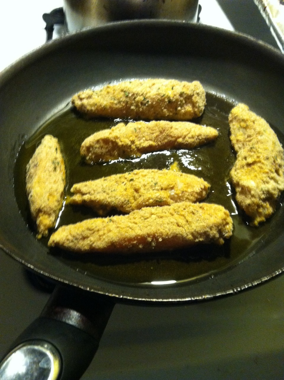 Place chicken in heated oil and fry about 3-4 minutes on each side, or until the outside is a deep golden brown.