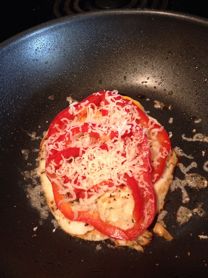 Add your bell peppers on the egg then grade some fresh parmesan cheese on top to melt