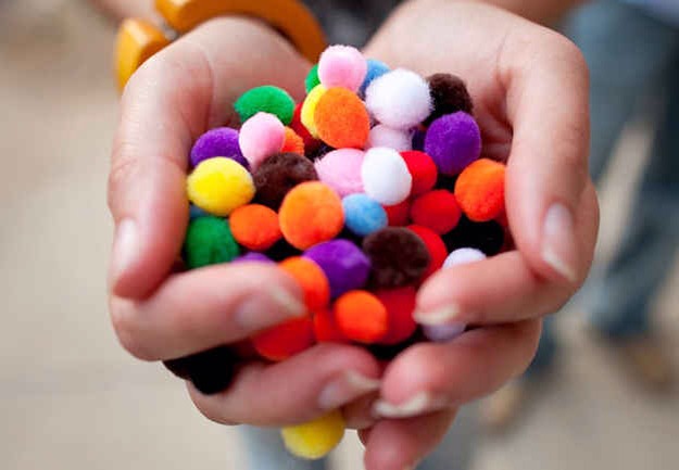 Forgo the confetti for pom-poms.
Your photos will be so much more colorful!