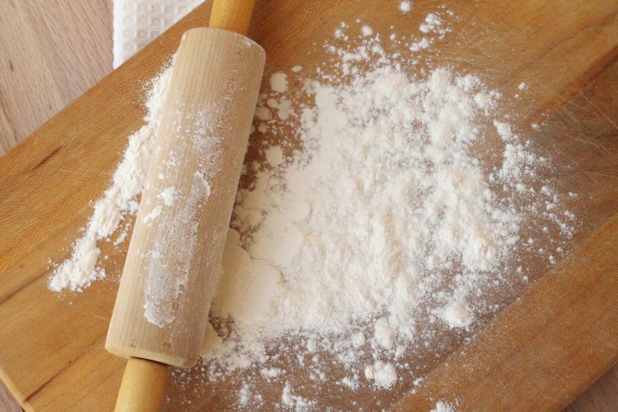Sprinkle some of the remaining flour onto a flat surface. Turn the dough out onto the board and sprinkle the top of the dough lightly with flour if sticky. With floured hands, fold the dough in half and pat it into a 1 ⁄ 3- to 1 ⁄ 2-inch-thick round.
