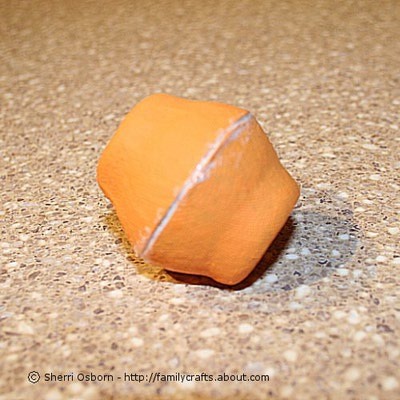 Put a bead of glue around the edges of the egg carton cups. Place the two glued edges together as shown in the photo. Smooth out the extra glue with your finger and let the glue dry.