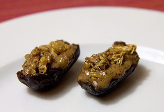 Almond-Butter-and Granola-Filled Dates 
Cut a date in half, remove the pit, fill it with some almond butter, top with granola, and yum! This snack tastes like dessert.