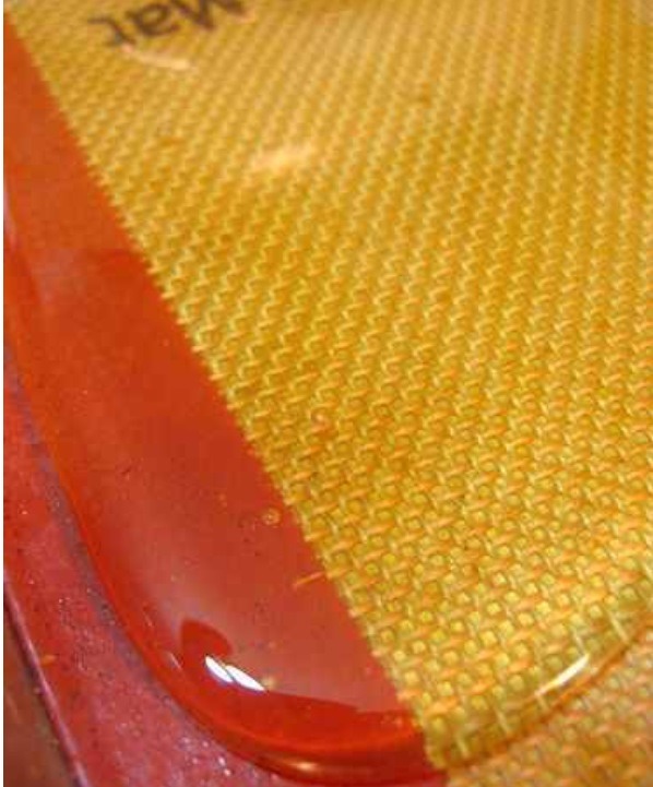 Line a few baking sheets with Silpat nonstick baking mats or parchment paper.
Pour the melted sugar mixture in a line down the center of the pan.  Using a skewer or the flat edge of a large knife, spread sugar into a thin flat sheet.  Glass slides are pretty thin, so the thinner the better.  