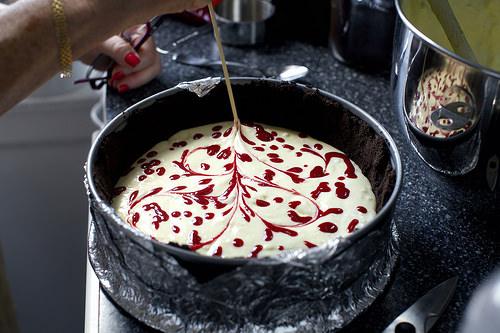 Using a squeeze bottle, piping bag or a zip-lock bag with a tiny corner snipped off, place tiny droplets of raspberry sauce all over top of cake. Use a toothpick or skewer to swirl the sauce and filling together decoratively.Extra sauce makes a delicious dessert sauce to serve with the cake. 