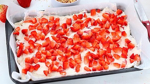 6)With rubber spatula, fold whipped topping and 1 cup of the chopped strawberries into cream cheese mixture. Spread over cookie crust. Top with remaining chopped strawberries.