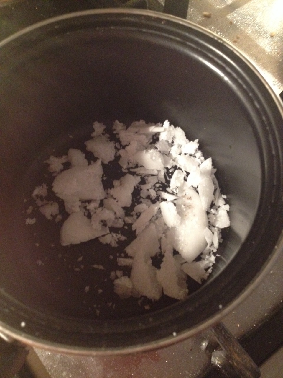 Chop up some of the candle and put it in the pan 