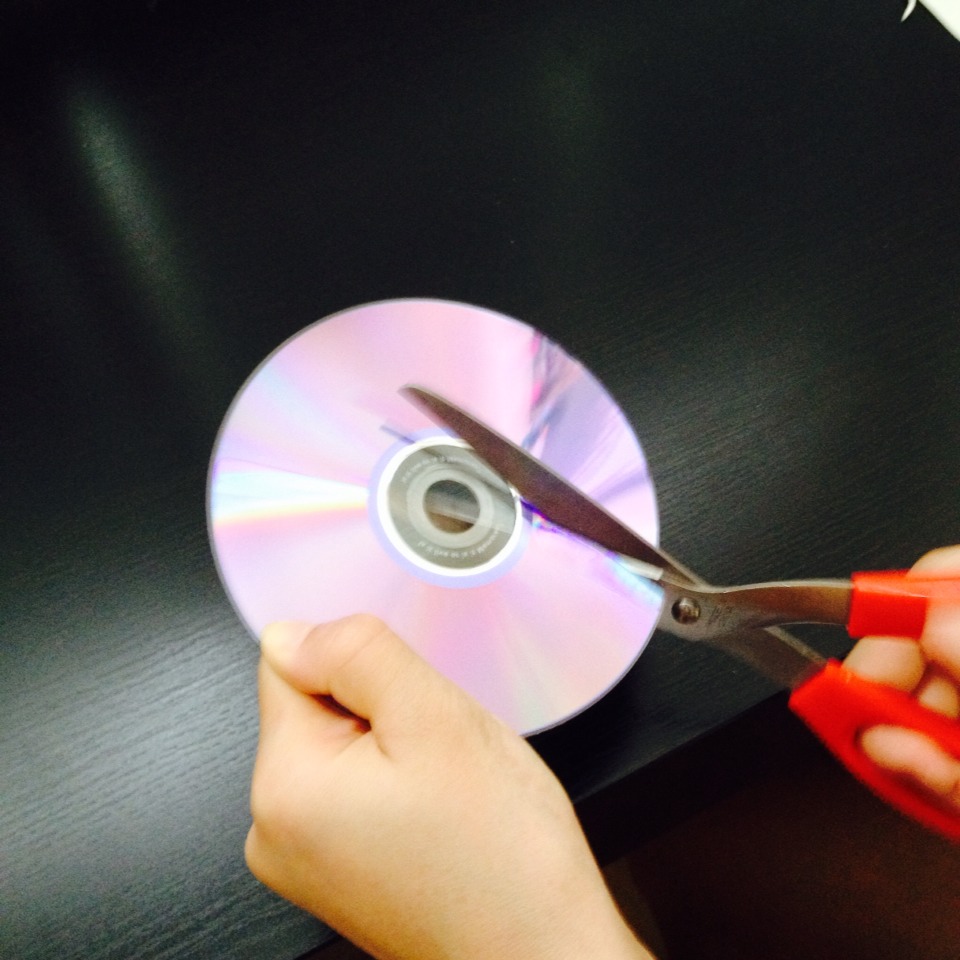 Use your scissors to cut out pieces from the cd