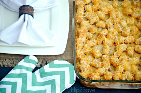 Arrange tater tots evenly over beef layer. In a small bowl, stir the soup into the milk until smooth; pour over tater tot and beef layers. Sprinkle Cheddar cheese evenly over the top.

Bake in preheated oven for 30 to 40 minutes, until cheese is bubbly and slightly brown.

Enjoy! 
