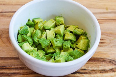 Dice up 2 medium avocados, and toss them with 1 T fresh-squeezed lime juice.