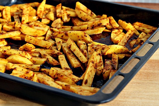 12. Spray or brush a baking sheet with vegetable oil generously.

13. Then place the wedges on the baking sheet.