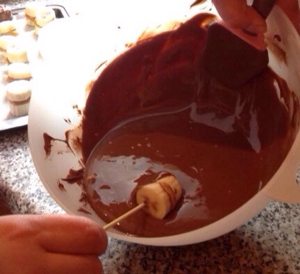 Once frozen, melt chocolate, coat the banana. Put back in freezer for about half an hour.   