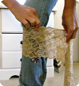 Start by wrapping the lace around your leg (right under your knee). Cut the lace. It's ok to put it over your pants, as this is probably how you are going to wear it anyway. 