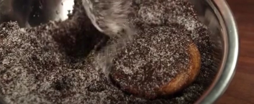 While churros are warm roll them into the sugar Oreo mix