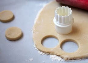 Dip the round cutter in flour and cut as many circles out of the dough as you can. Remove scraps, re-knead and repeat. Make sure to reflour the work surface too.