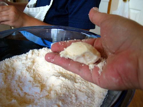 If the mix starts to foam, you are adding the liquid too fast. Quickly whisk the reacting ingredients into the nonreactive part and the reaction should stop. Add a teaspoon at a time. When wet ingredients have been added, you should have a mix w/ the consistency of damp sand. Should clump together.