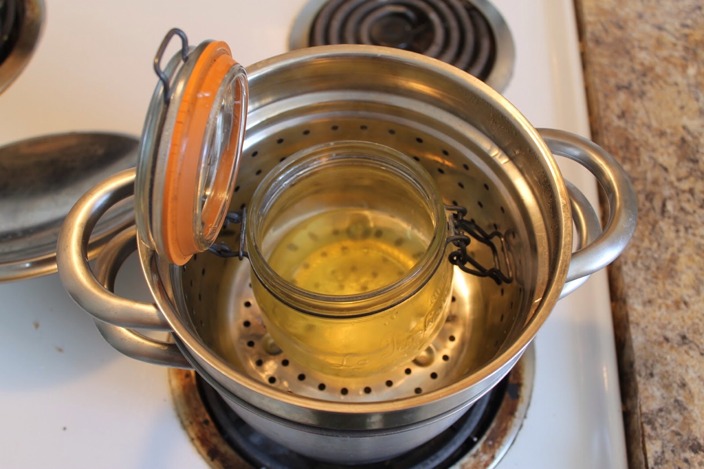 Add a small amount of water to a pot about an inch or so and put the jar in. Turn the flame to low and stir the coconut oil and crayon until they melt together