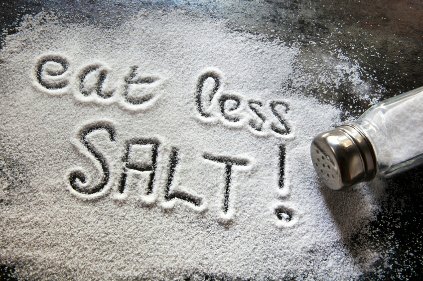 Stop adding salt to your meals. It may seem bland at first, but you'll get used to it. 

Salt causes you to retain water and makes you bloated, so avoid it whenever you can. 