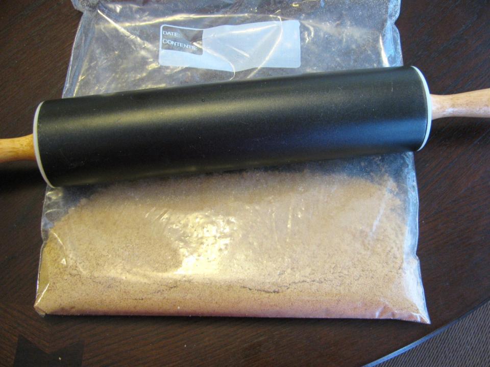  Crush the graham crackers.  I find it easiest to put them in a plastic bag and crush them using a rolling pin or a bottle will also do the trick.