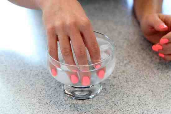 Put your freshly painted nails into a bowl of cold water it will help them dry quicker