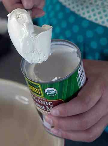 Scoop the coconut cream off the top of four 13.5 oz cans of coconut milk that have been refrigerated overnight to firm up the cream, and place in a medium bowl.