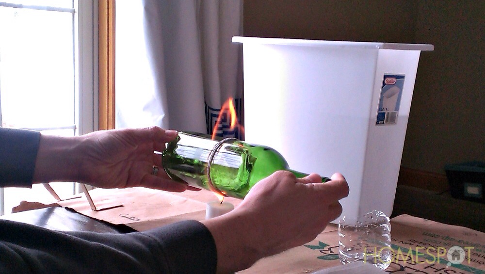 Dip the yarn in polish remover and tie it around the part you want spit. As shown above, a candle is our safest bet. Spin the on fire bottle for ten seconds and wala!