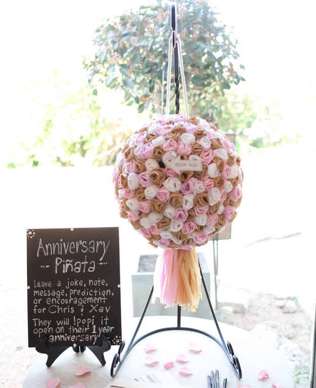 Instead of a guest book, have your guests leave a message for you in an "anniversary piñata."
It's like a time-capsule guestbook! You'll really have something to look forward to when you break it open a year later. \^.^/