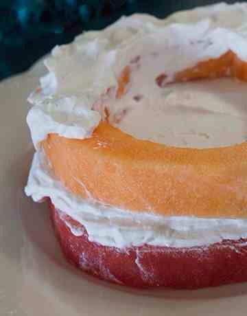 Pat cantaloupe dry and add to cake, add another generous layer of frosting.
