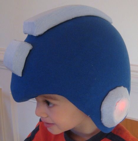 Back on the helmet I threaded around the led, so I could cut a hole in the fabric without worrying about it ripping apart.

Finally I hot glued these 4 pieces to the helmet, completing this stage of the build.