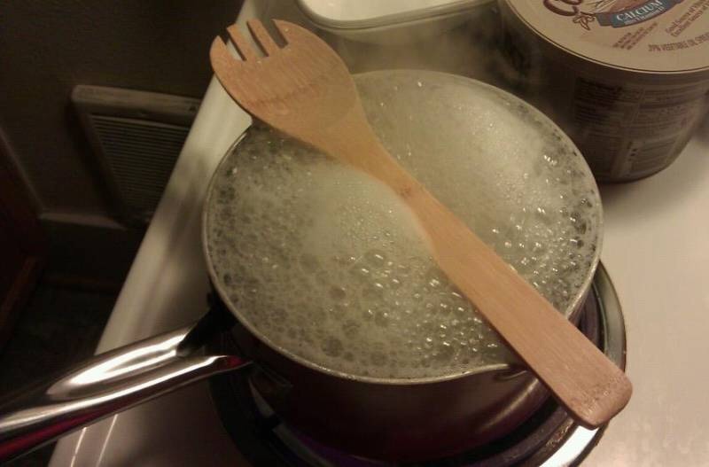 Place a wooden spoon over a pan to stop it from boiling over