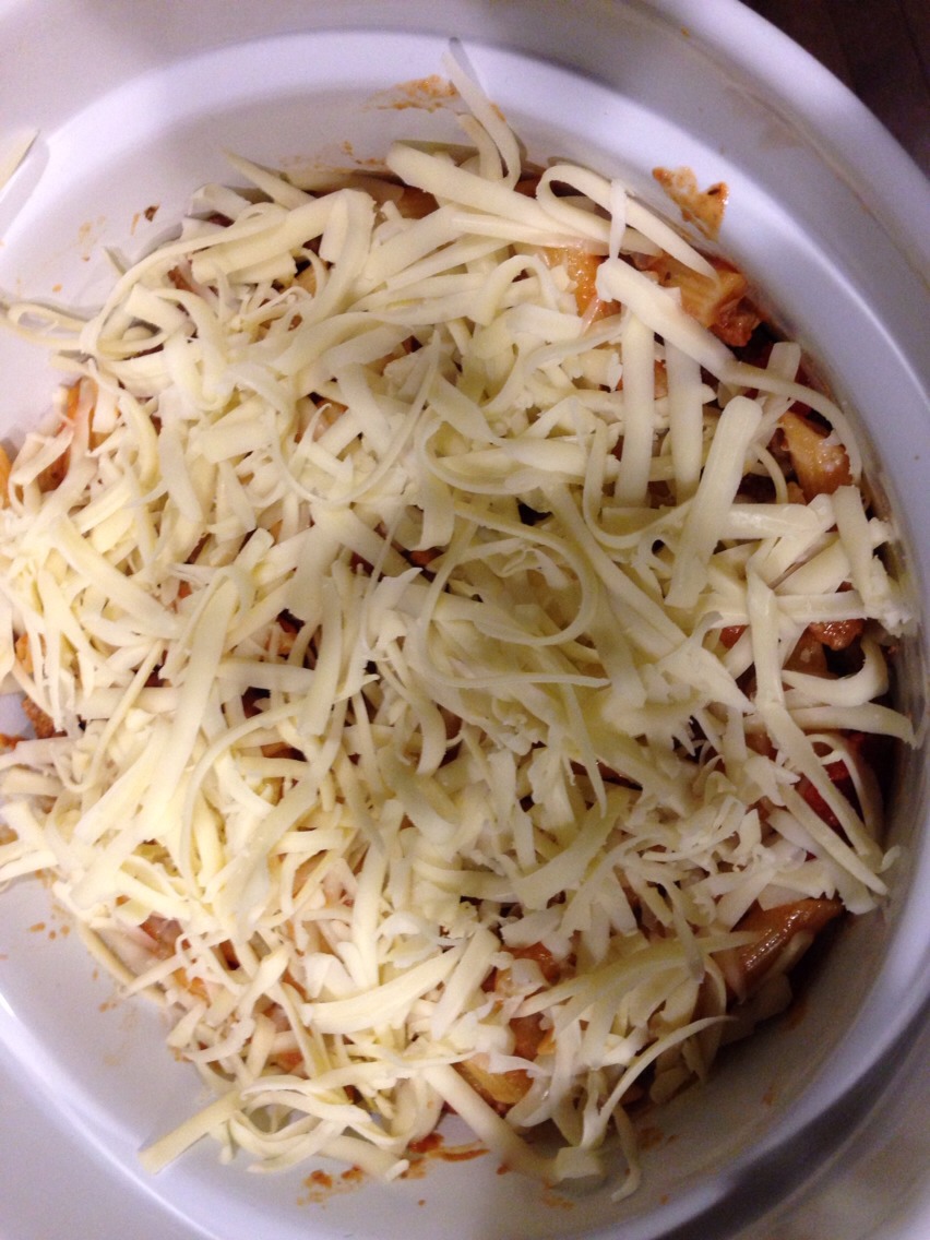 When noodles and sauce are complete mix together in the pot. Then get your dish ready and fill only the bottom layer with your pasta then put some shredded mozzarella on top.