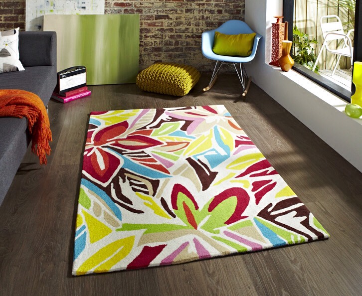 Add rugs. Rugs aren’t just for hardwood floors. If you have neutral wall-to-wall carpet, consider throwing a colorful or patterned rug over the floor. The modern rug will be a design focus, drawing attention away from the carpet.