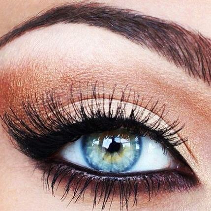 copper and black eye makeup, blue eyes pop.