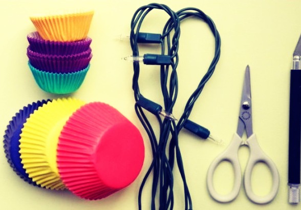 For this DIY project, you will need cupcake papers of two different sizes, scissors, string lights, and an exacto knife :)