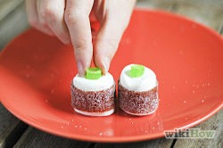 Cut a jelly bean in half and place it on the marshmallow, inside facing up.