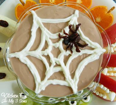 into a bowl reserving about 1/2 cup. Mix the 1/4 of Nutella with the yogurt. Spoon the reserved yogurt in a baggie then snip off the corner. Squeeze on a web on the top. We made the spider using raisins, but you could also do this with dark grapes as well.