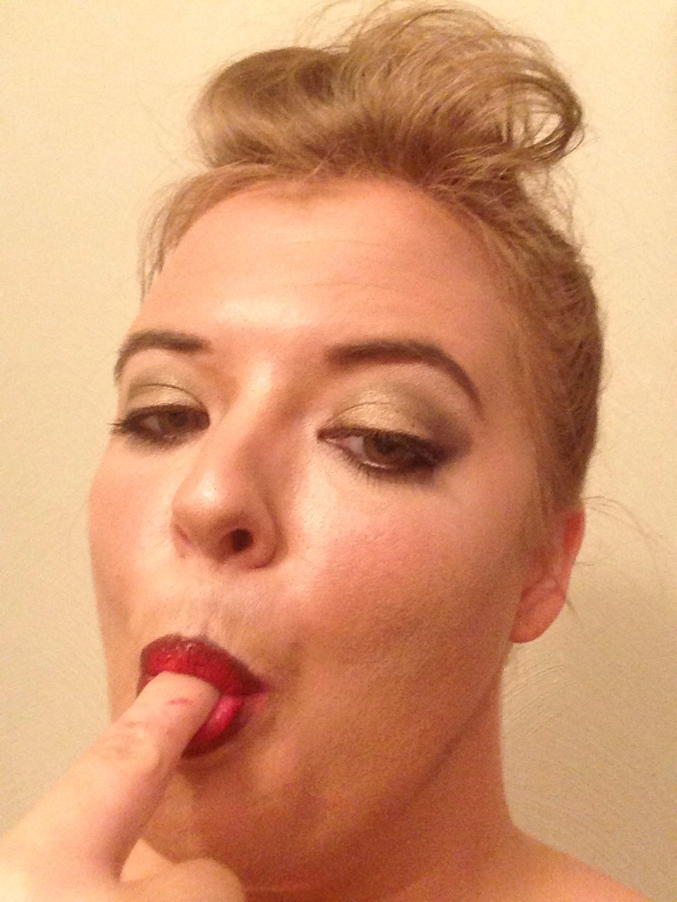 To make sure no lipstick transfers to teeth, put your finger in your mouth, close, and pull  it out.