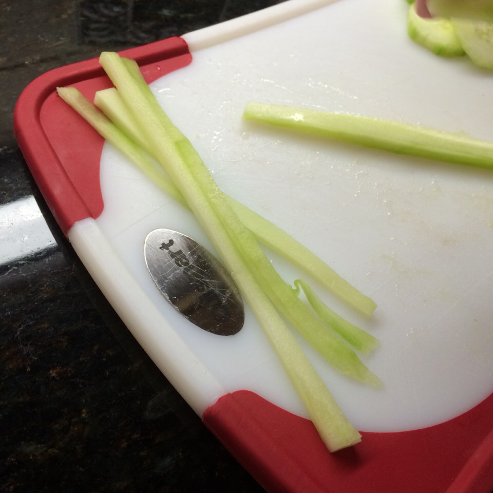 Slice the peeled cucumber into thin strips like the ones above. Slice the avocado like the ones in the previous picture.