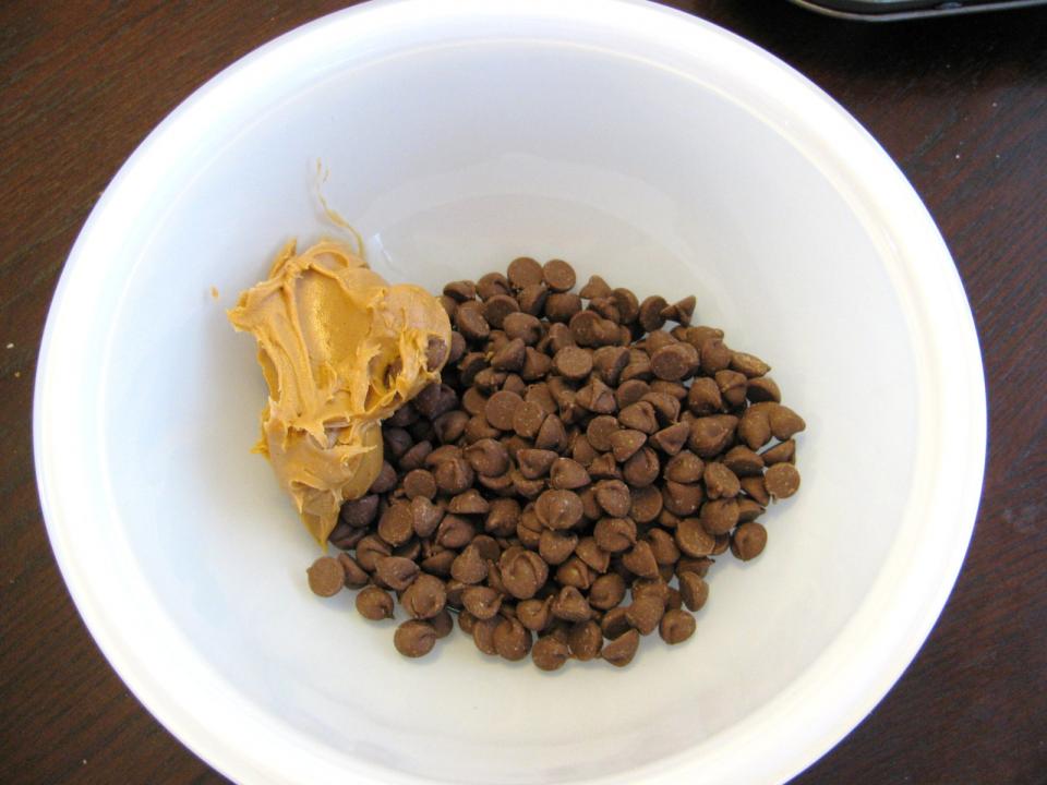 Combine the peanut butter and chocolate chips in a microwave safe bowl. 

