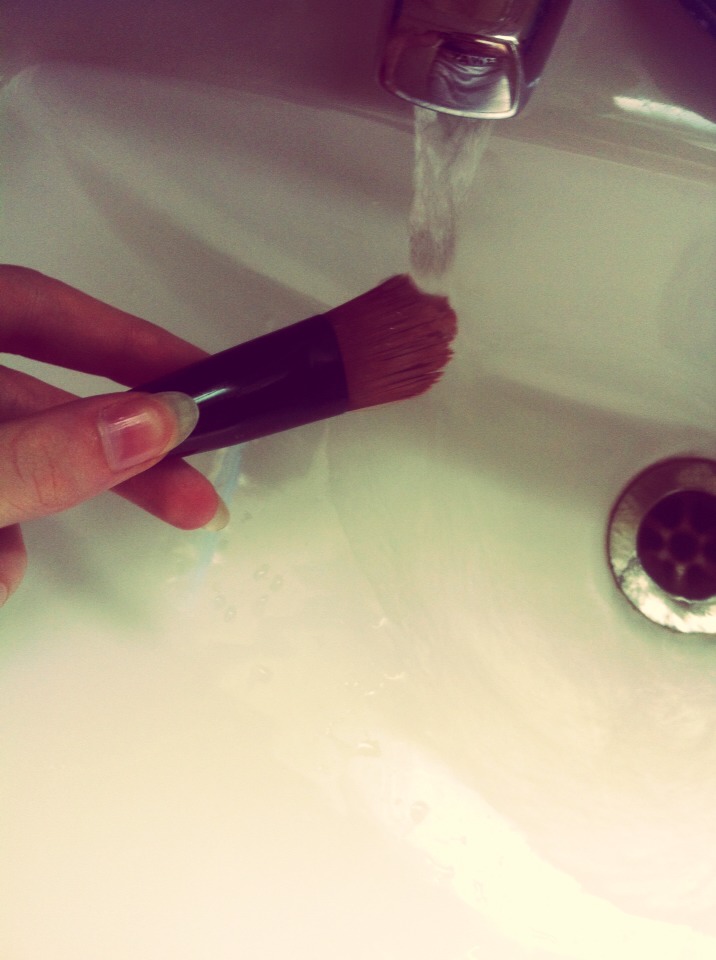 Hold your dirty brush under the tap (hot or cold water) to make it damp.