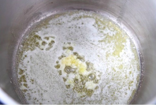 Step 2: Once melted, add in the minced garlic and stir.