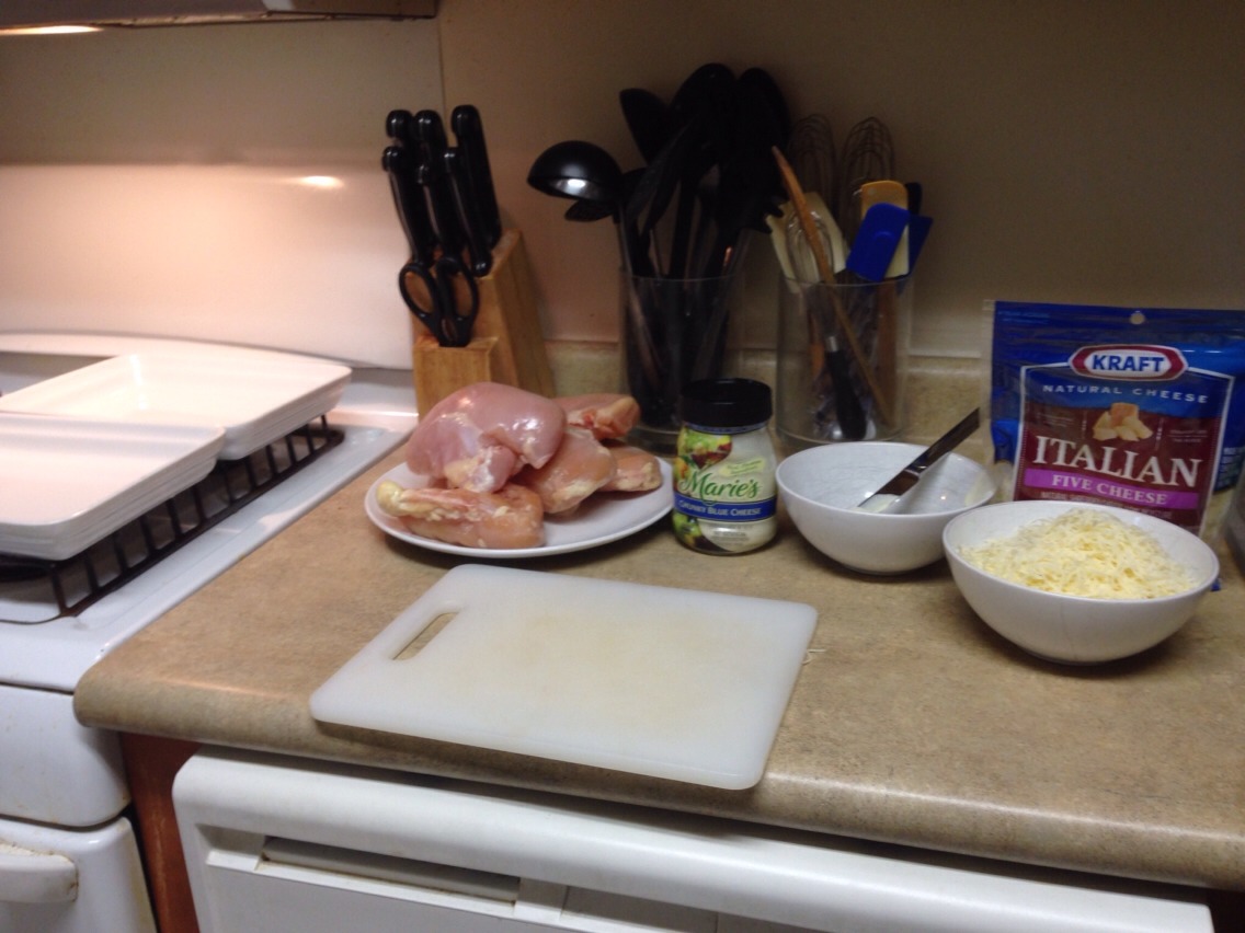 You will need boneless, skinless chicken breasts, blue cheese (or mayo if you prefer), bread crumbs, and shredded white cheese (Parmesan is best, but my family prefers an Italian mix).