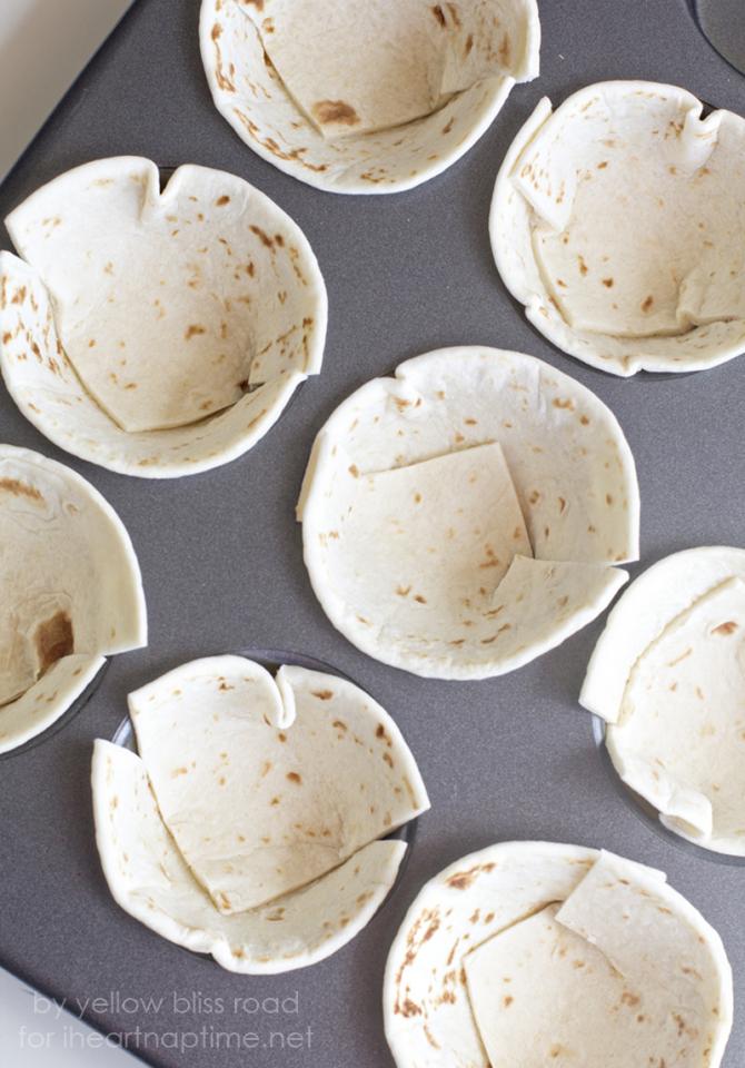 Cut a few flour tortillas into quarters and press them into grease muffin tins to form a cup. Sprinkle a little cheese into the bottom of each cup. (You can skip the cheese to cut a few more calories). Bake in a preheated 350 degree oven for about 8 minutes, remove from the oven and set aside.