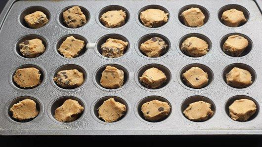 1) Heat oven to 350°F. Spray 24 mini muffin cups with cooking spray. In each muffin cup, place 1 piece of cookie dough from 1 package Pillsbury™ Ready to Bake!™ refrigerated chocolate chip cookies.